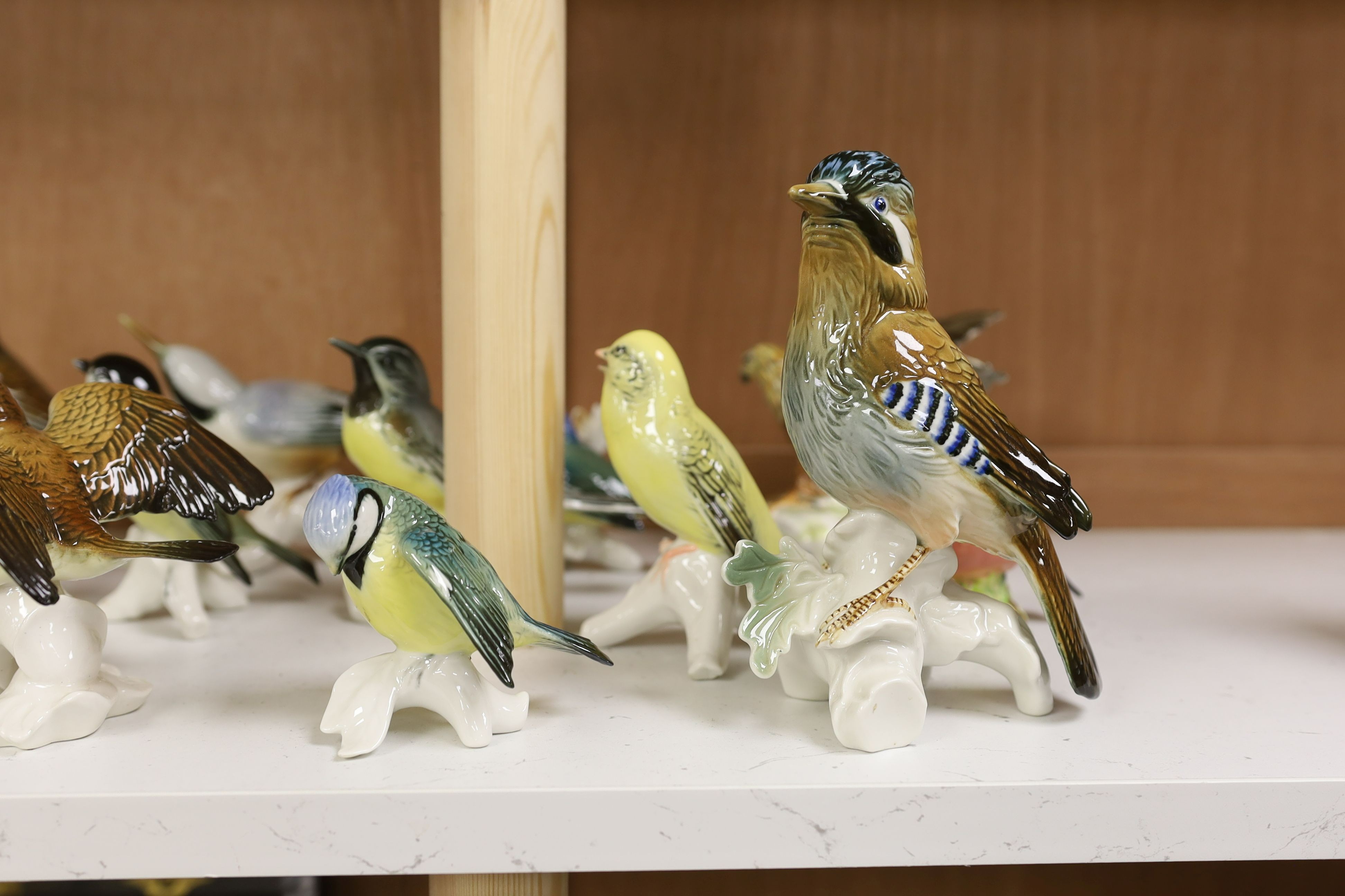 A large collection of ceramic bird figures including Beswick, Russian models, Karl Ens etc